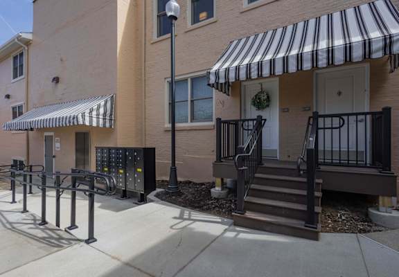 A building with a striped awning and a black and white door.