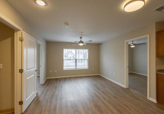 A room with a ceiling fan and a window.