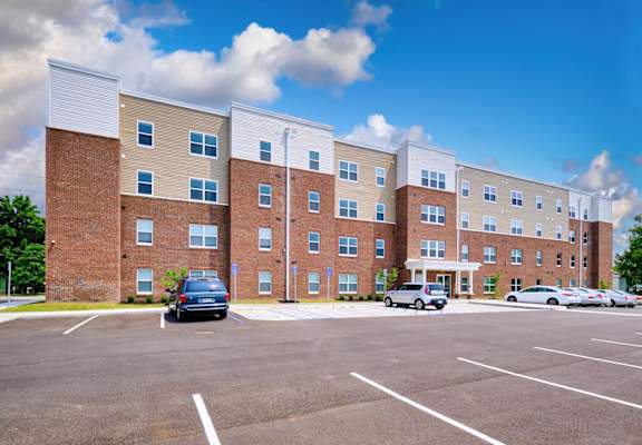 a large brick building with a parking lot in front of it
