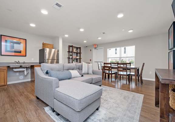 a living room with a couch a table and a sink