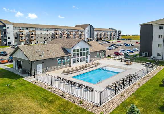 A large building with a pool in front.