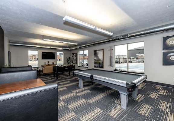 A room with a long table and a bench.