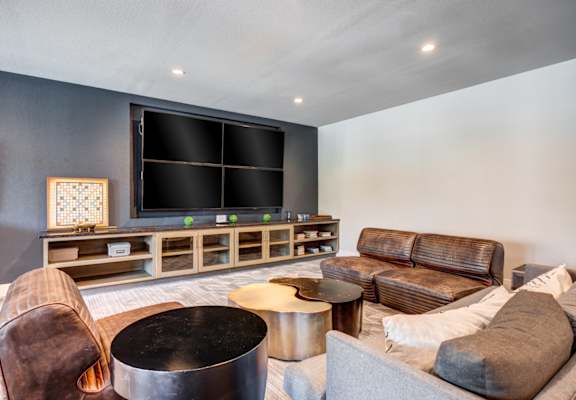a living room filled with furniture and a large flat screen tv at AMARA, San Antonio, 78257