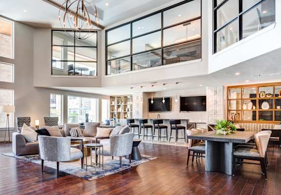 a living room filled with furniture and a large chandelier at AMARA, San Antonio, 78257
