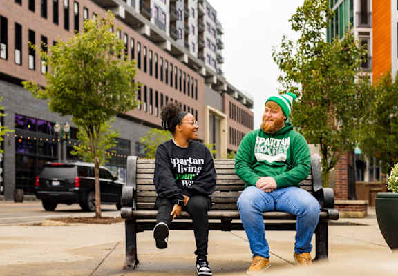 two people sitting on a park bench