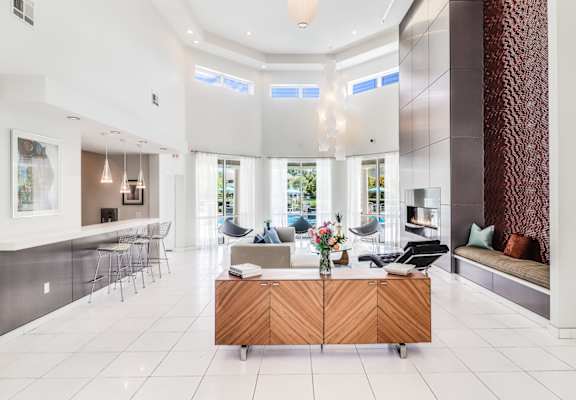 A modern living room with a wooden cabinet in the middle.