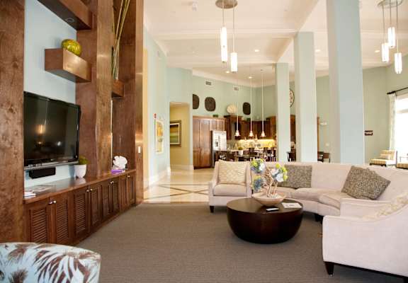 A living room with a white couch and a wooden entertainment center.