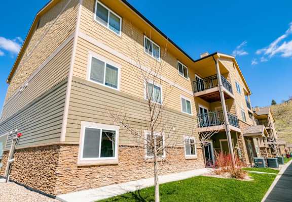 A multi-story residential building with a balcony on the upper floor.