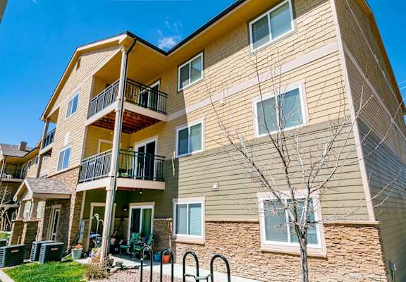 A two-story apartment building with a balcony on the second floor.