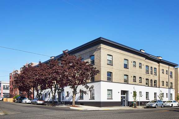 A modern building with a parking lot in front of it.