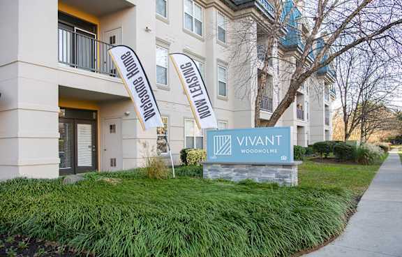 Vivant Woodhome sign in front of a building. at Vivant Woodholme, Pikesville