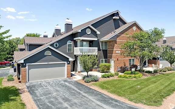 A large house with a grey garage door.