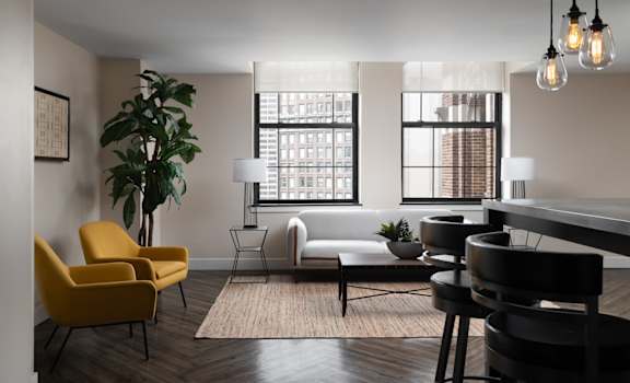 a living room with a piano and a table and chairs