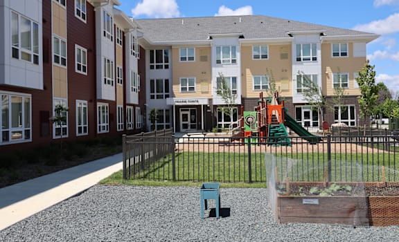 Apartment complex with a playground and a slide.
