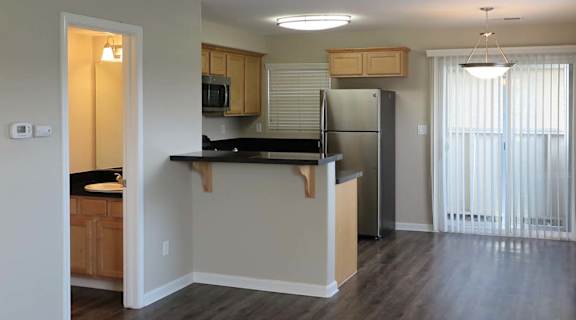 view from living room into kitchen showing wood floors