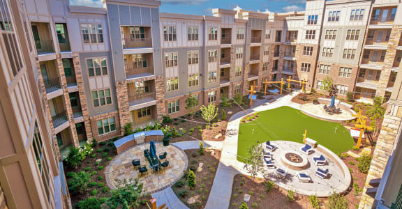 an aerial view of an apartment complex with a playground and fountain