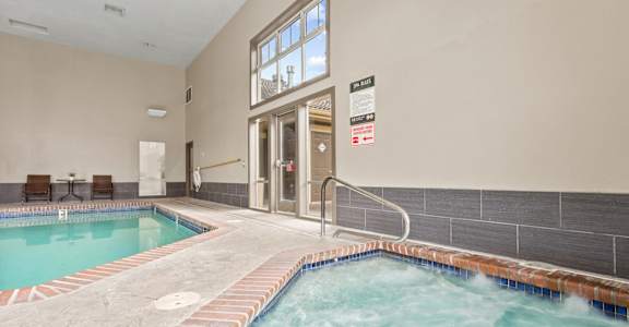 A hot tub in a room with a glass door at MonteVista Apartments, Beaverton, Oregon
