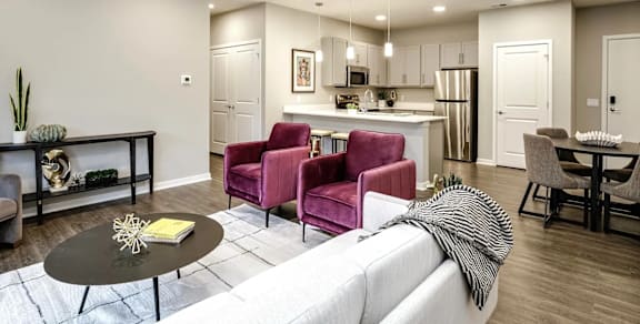 A kitchen with a red chair and a white counter.