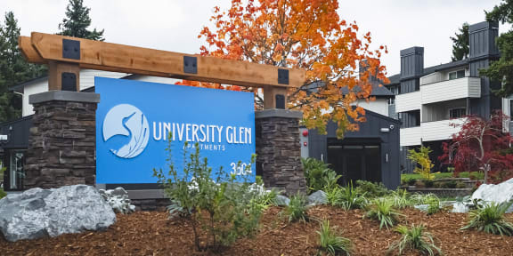 a blue university center sign in front of a building  at University Glen, University Place, WA