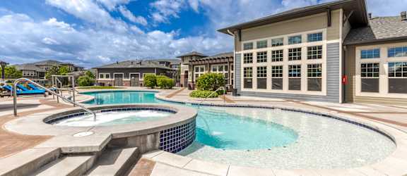 a swimming pool with a building in the background