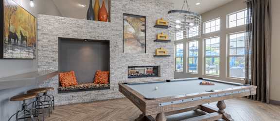 a game room with a pool table and a fireplace