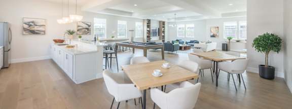 A modern kitchen with a dining table and chairs.