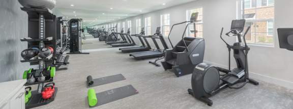 A spacious gym with a variety of exercise equipment.