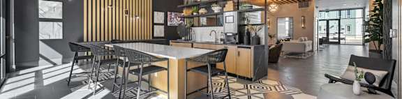 A modern dining area with a black and white floor and wooden accents.
