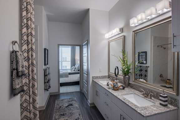 A bathroom with a large mirror and a sink.