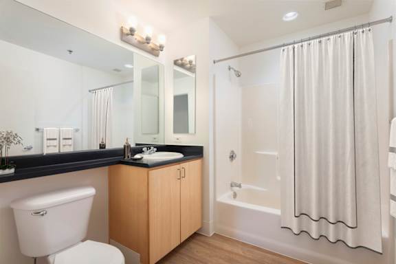 A white toilet sits next to a sink in a bathroom.