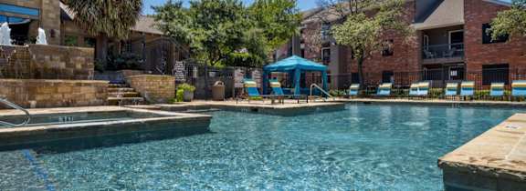 A large house with a pool in front.