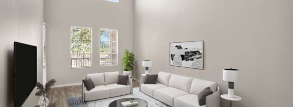 A living room with a white couch, a coffee table, and a flat screen TV.