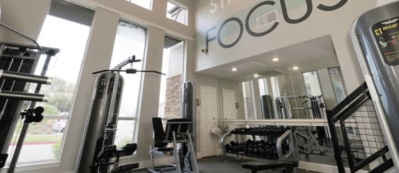 a home gym with a sign that says strength focus