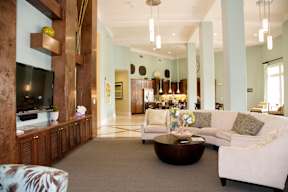 A living room with a white couch and a wooden entertainment center.