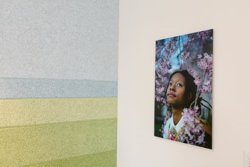 a photo of a painting of a girl with flowers on a wall