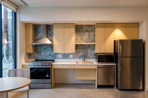 a kitchen with stainless steel appliances and a table