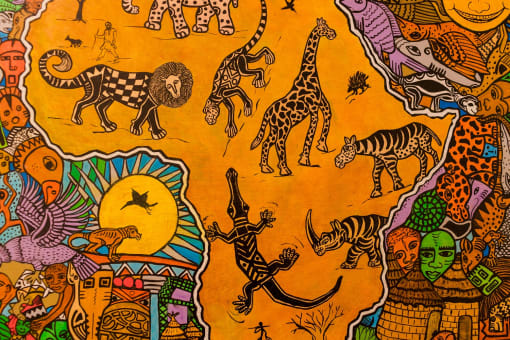 a close up of an orange cloth with various animals on it