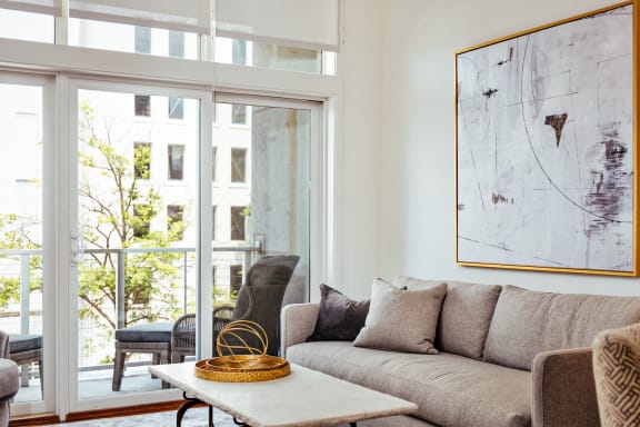 a living room with a couch and a table     and a balcony at 20 Midtown, Birmingham, 35233