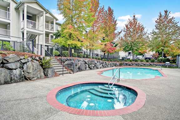 A small pool with a red border and a ladder in the middle.