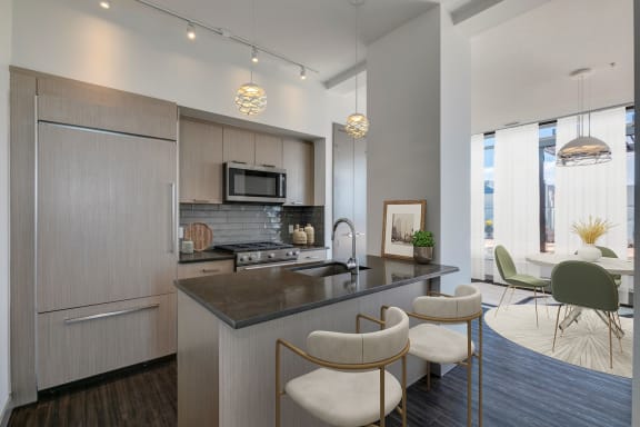 a kitchen and living room with a table and chairs at Versus, Calgary, AB, T2R 1A8