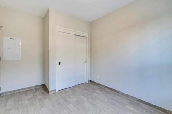an empty room with white walls and a door