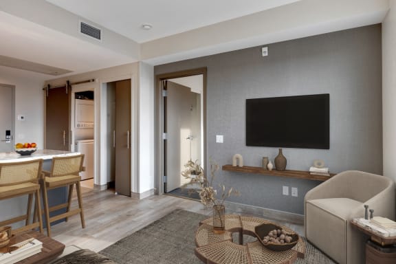 a rendering of a living room and dining room with a television