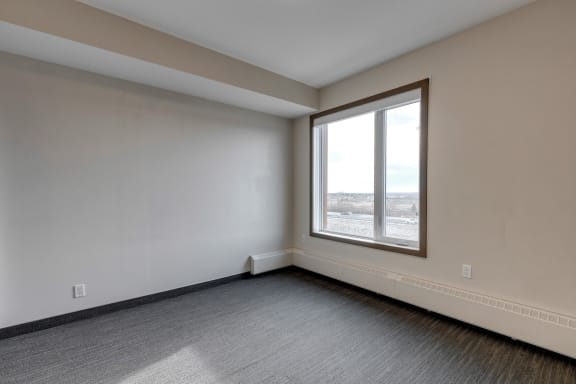 an empty living room with a large window