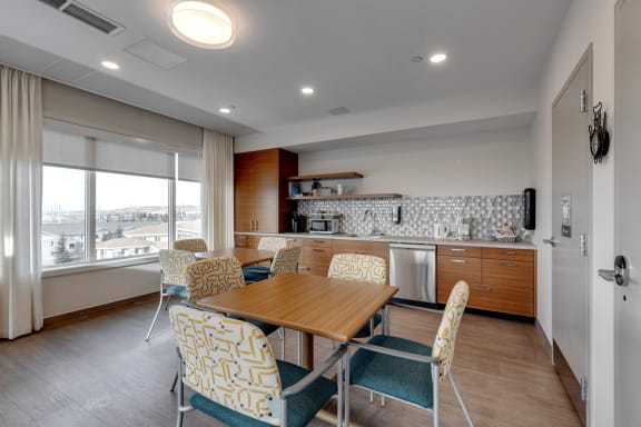 a dining room with a table and chairs and a kitchen