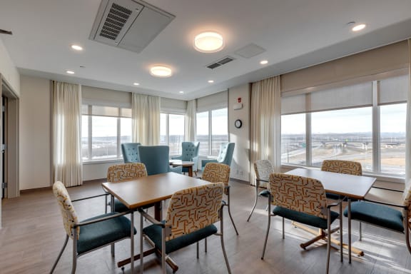 a conference room with tables and chairs and a large window