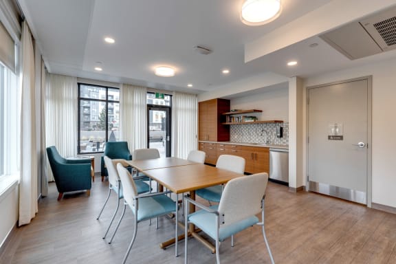 a dining room with a wooden table and chairs