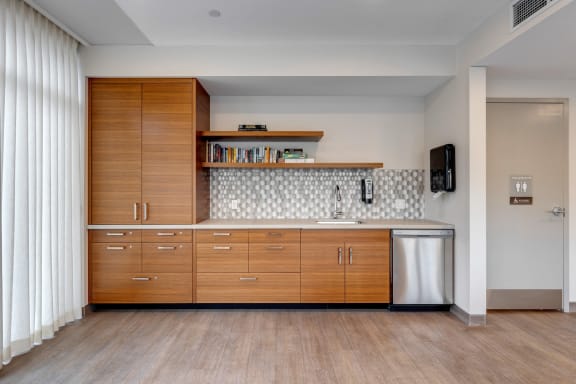 a kitchen with wooden cabinets and a sink and a refrigerator