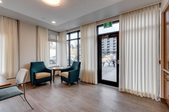 Corner space with two teal chairs at Westview
