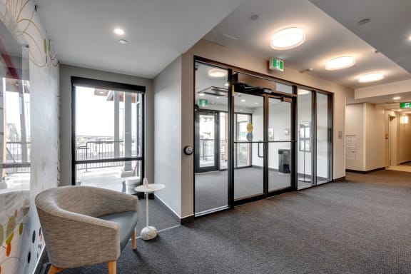 a conference room with glass doors and a chair