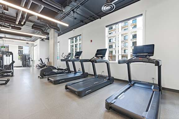 A gym with treadmills and other exercise equipment.